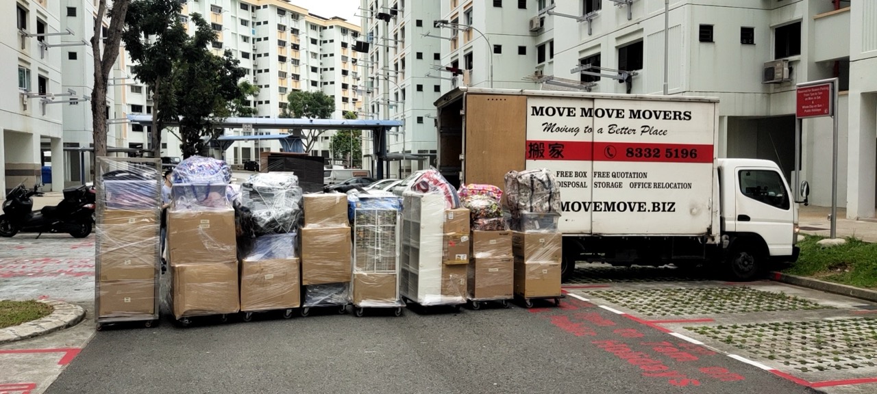 Loaded household moving trolleys beside a Move Move Movers lorry