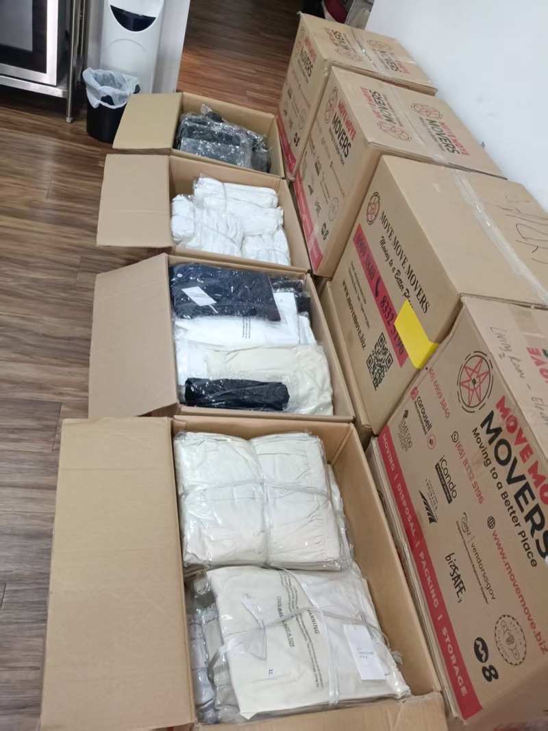 Packaged white and dark garments in open cartons
