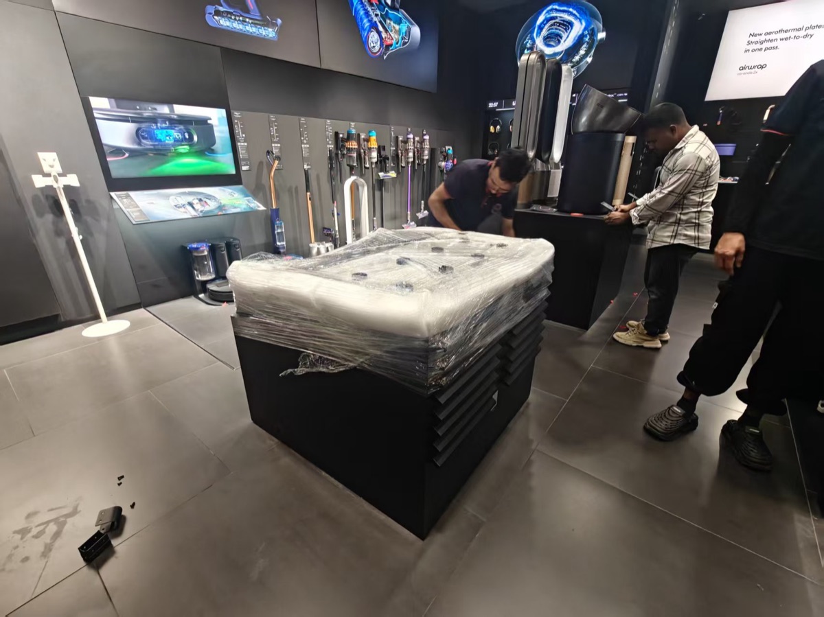 Protected Dyson retail fixture prepared for movement inside the store