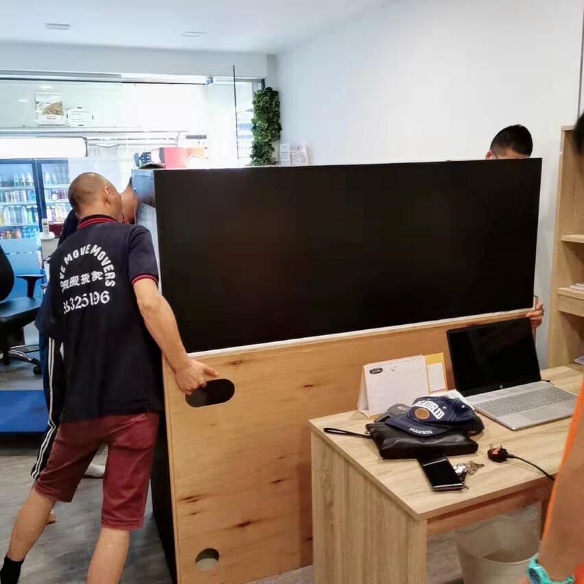 Large desk-panel carry inside a Singapore office