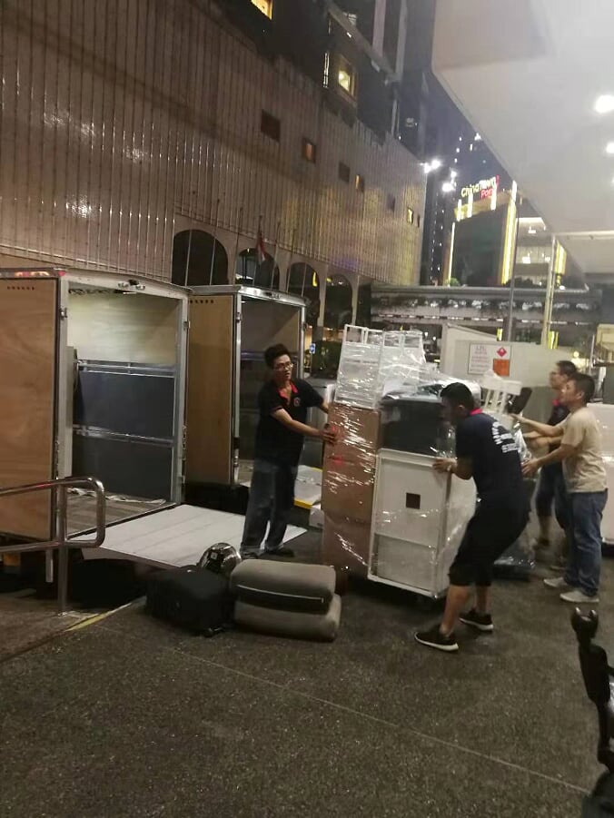 Move Move Movers crew moving commercial office equipment during a night relocation window