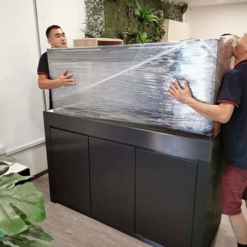Singapore aquarium movers wrapping and securing large fish tank for relocation