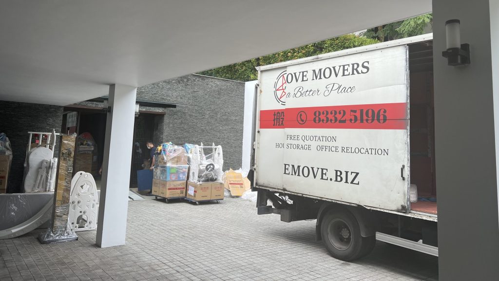 Weather-proof moving services for landed property in Singapore using car porch for safe loading during rain.