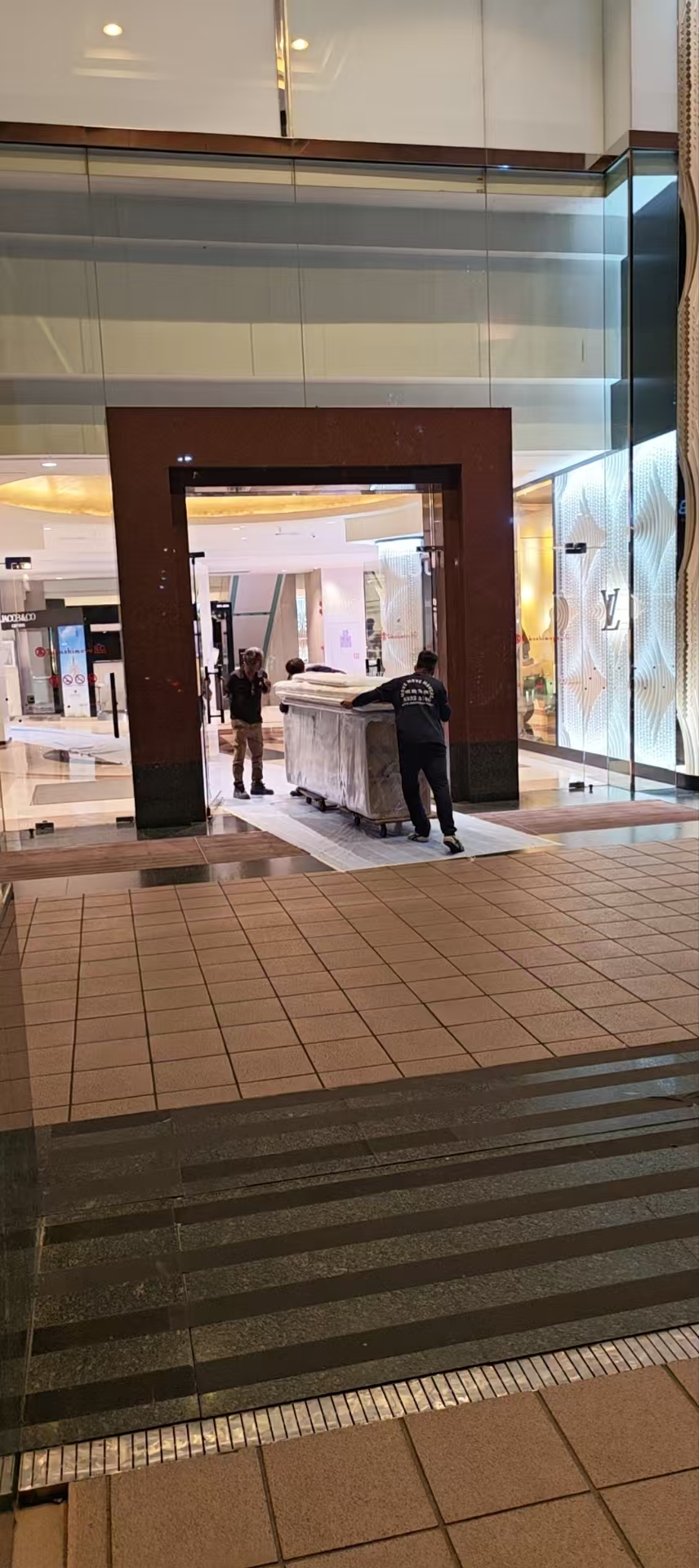 Loaded platform trolley moving through a commercial site in Singapore