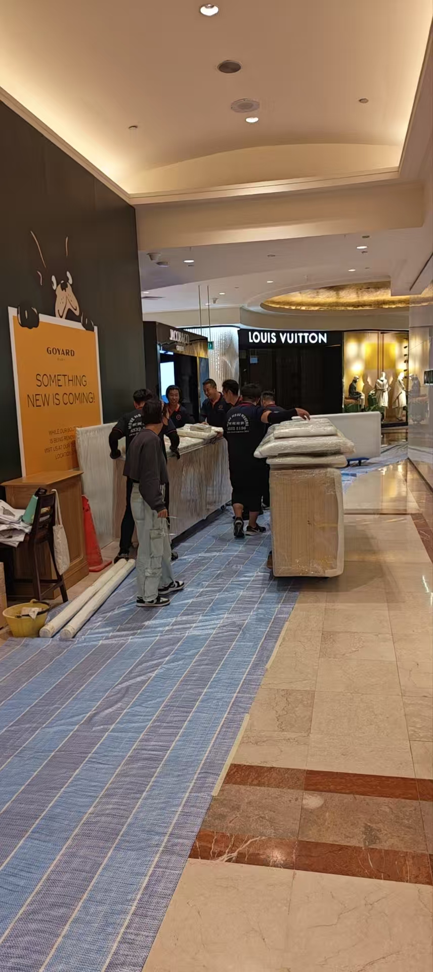 Protected commercial furniture moving through an indoor corridor in Singapore