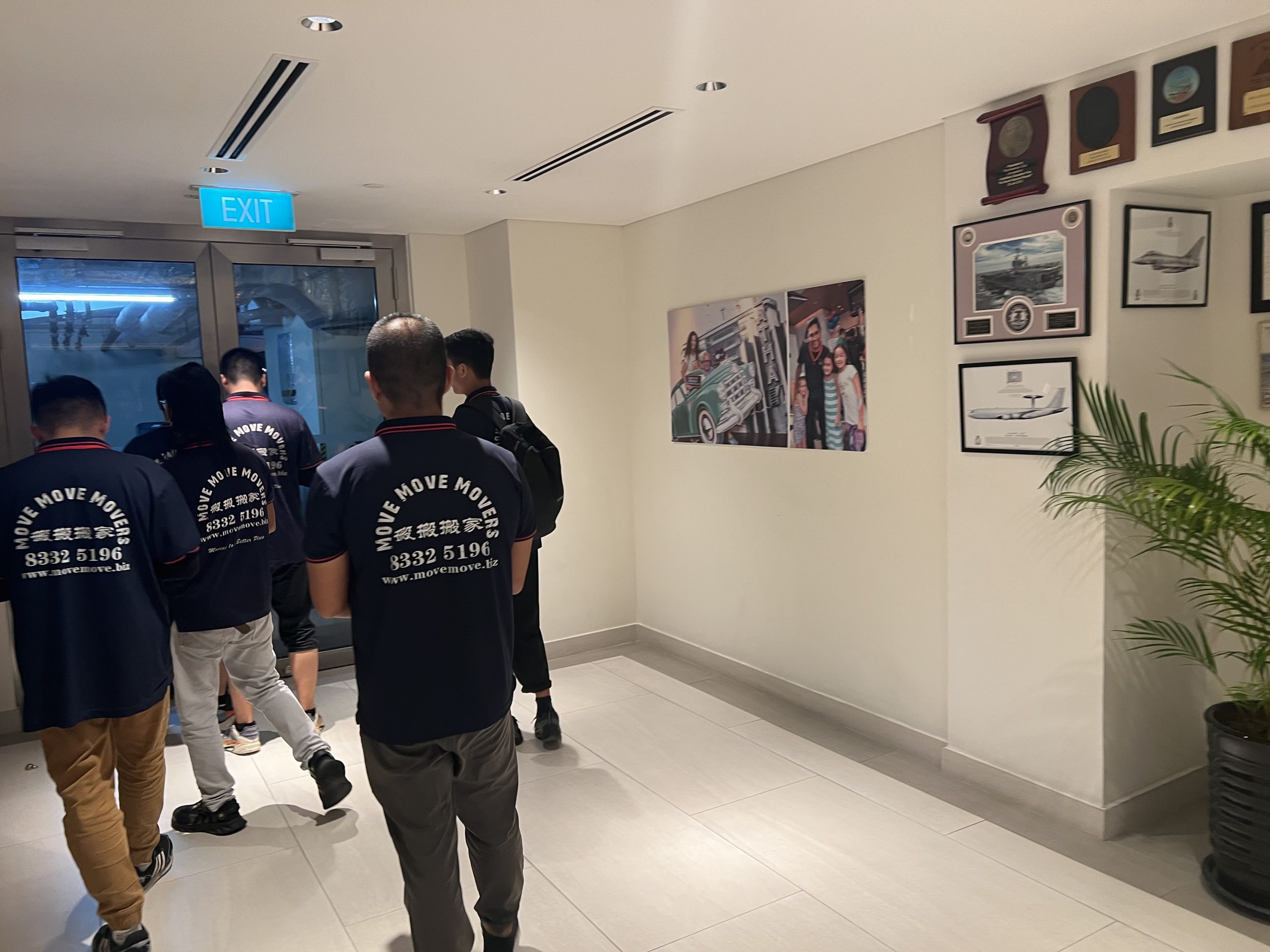 Crew moving items through a corridor with controlled access