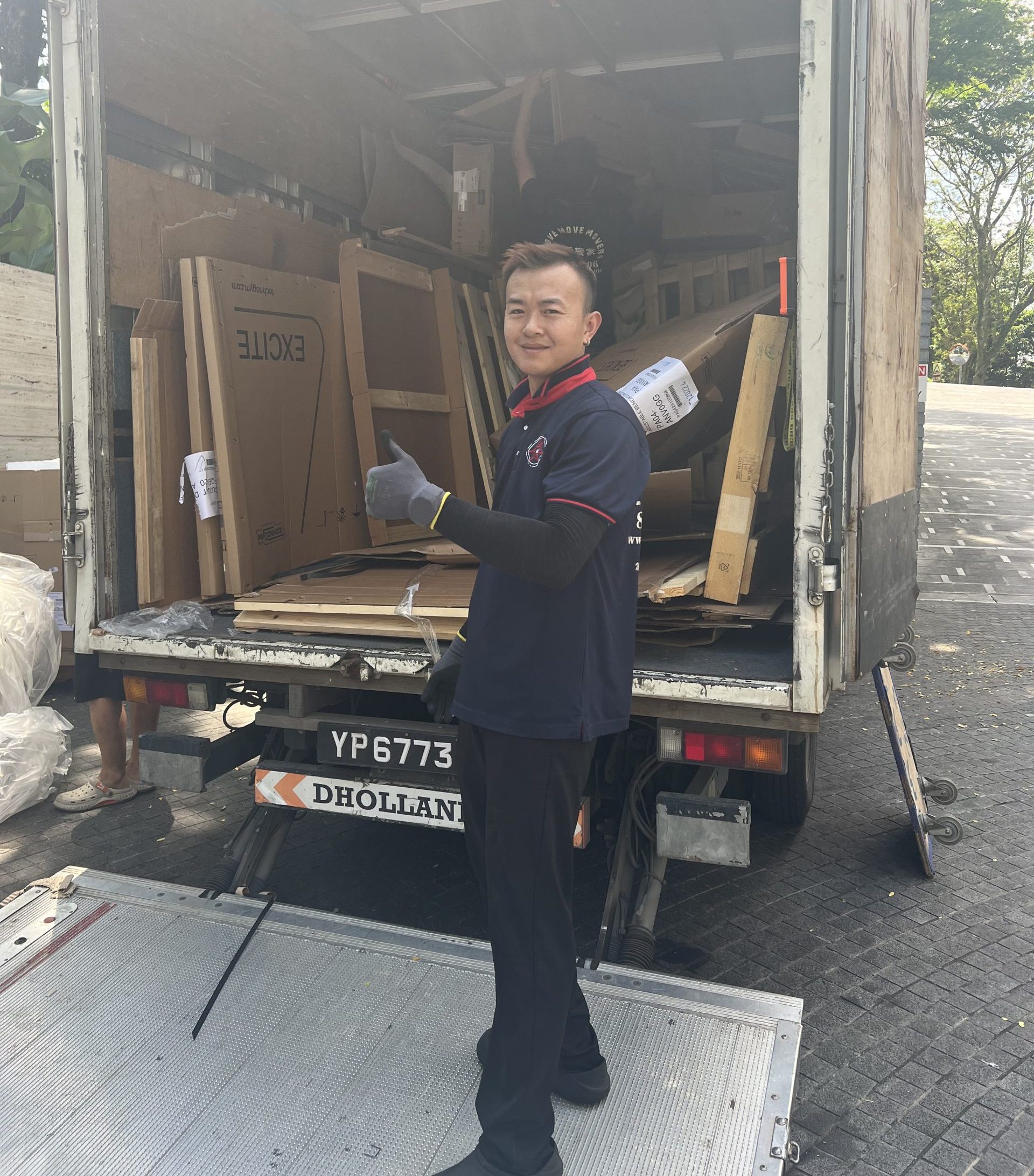 Oversized wardrobe panel being removed through a Singapore access route