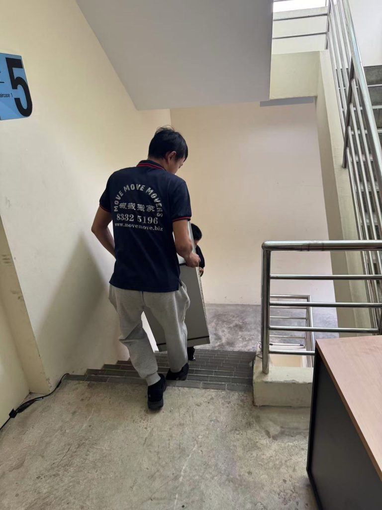 Move Move Movers crew handling wrapped furniture during a Singapore move