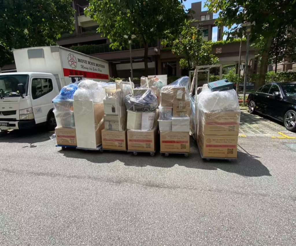 Move Move Movers crew handling wrapped furniture during a Singapore move