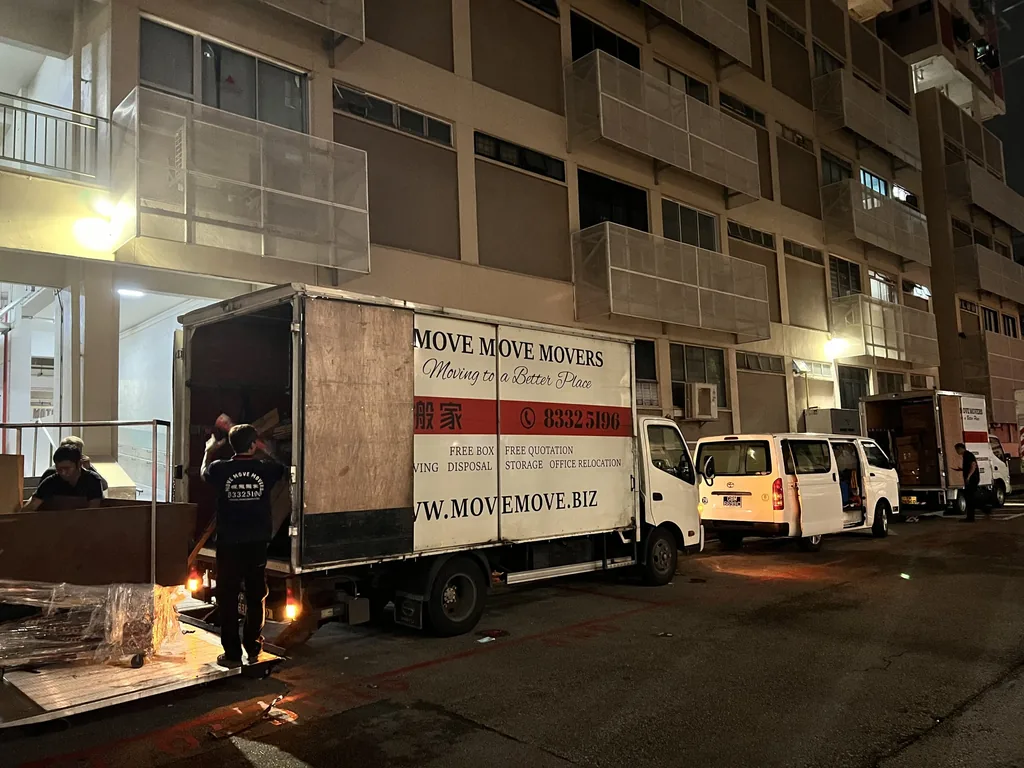 Move Move Movers crew loading commercial items into lorries after dark