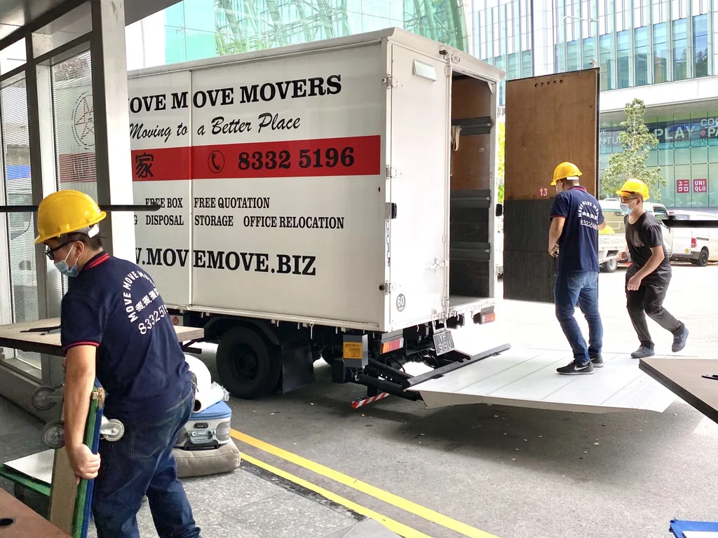 Move Move Movers crew and lorry at a covered commercial loading bay