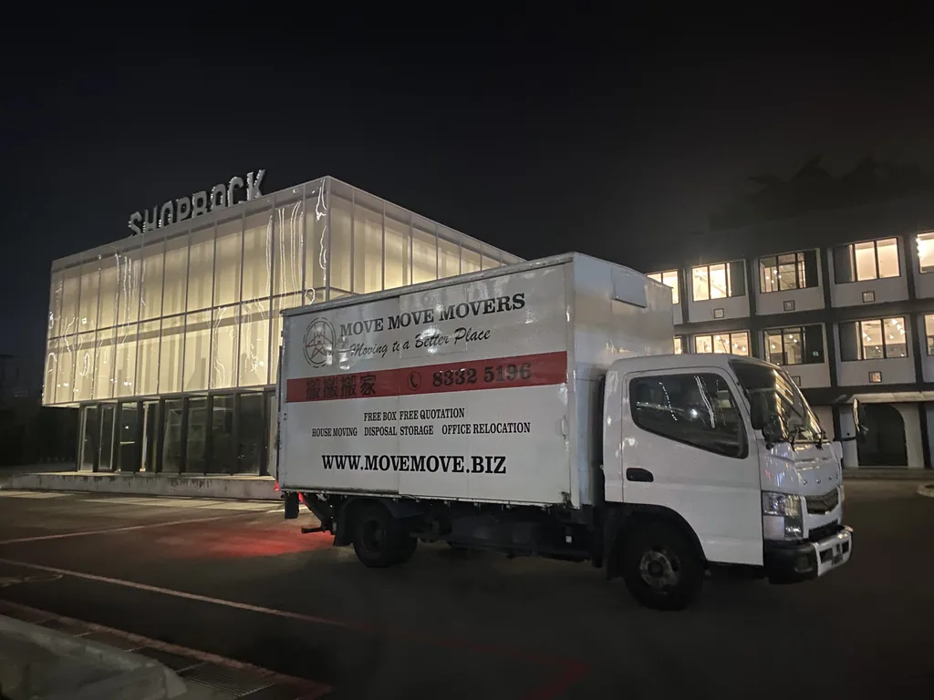 Move Move Movers crew and lorry at a commercial loading area in Singapore