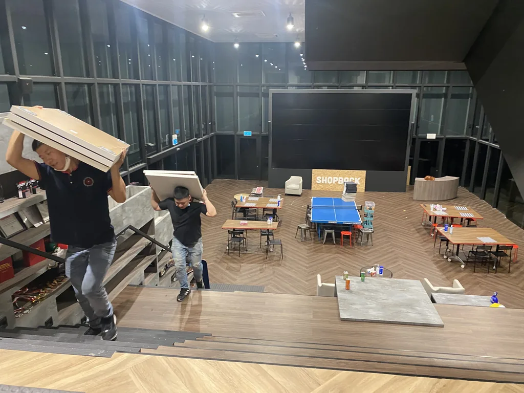 Move Move Movers crew carrying large office panels through a workplace